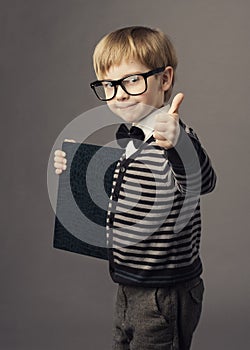 Boy little smart child in glasses showing blank card certificate