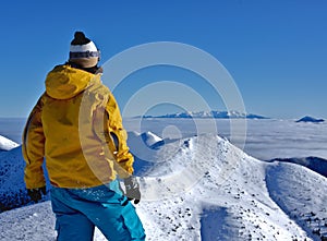 Boy lookig at the mountains.