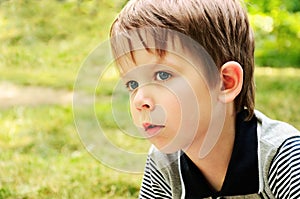 Boy looking away with interest in the park