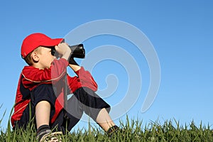 Boy looking through binoculars
