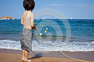 Boy looking at the blue sea