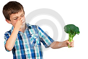 Boy Looking at Broccoli with Disgust photo