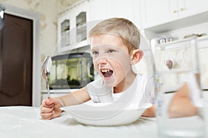 Boy is looking at an empty plate