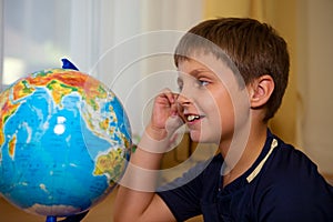 Boy looking globe