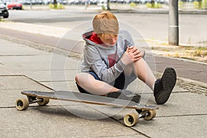 Boy Looking At His Injured Leg