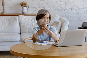 Boy looking at laptop showing sign language communicates with tutor