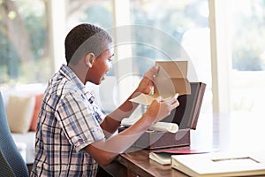 Boy Looking At Letter In Keepsake Box On Desk