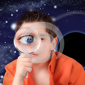 Boy looking with a magnifying glass