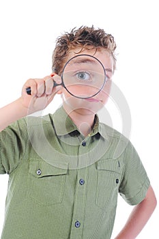 Boy looking through a magnifying glass