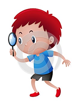 Boy looking through magnifying glass