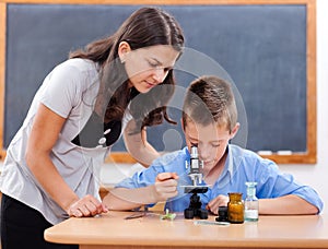 Boy looking into microscope