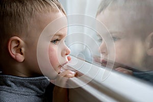 Boy looking out window