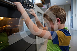 Boy looking at oven