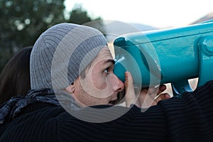 Boy looking through a telescope