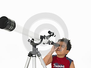 Boy looking through a telescope