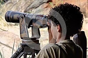 Boy looking through telescope