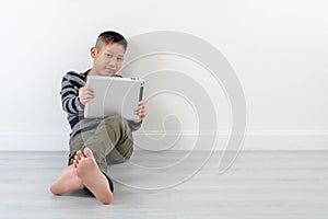 Boy looking at touch pad at home.