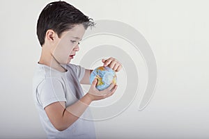 Boy looking at a toy globe