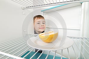 Boy Looks Empty Refrigerator