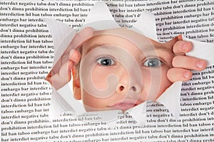 Boy looks into the hole in the sheet