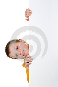 Boy looks out of blank banner isolated on white