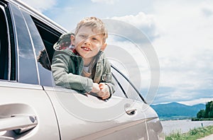Boy looks out from car window