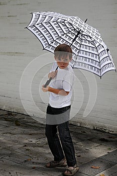 Rascal with many freckles under piano  umbrella photo