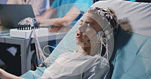 Boy lying in bed during EEG examination