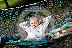 Boy lying on a hammock