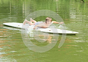 Boy lying on a surf