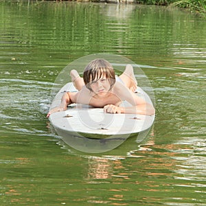 Boy lying on a surf