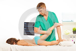 Boy lying on table and having a leg massage