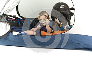 Boy with magnifiying glass and dog tenting