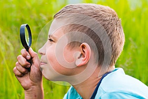 Boy with a magnifying glass