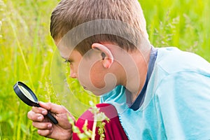 Boy with a magnifying glass