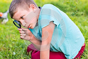 Boy with a magnifying glass