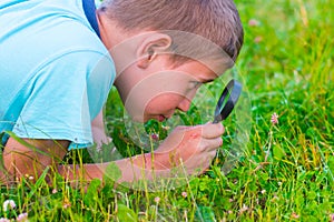 Boy with a magnifying glass