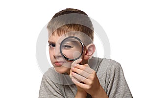 Boy with a magnifying glass in his hands. Little explorer. White background