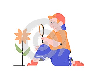 Boy with a magnifying glass looks at a flower.