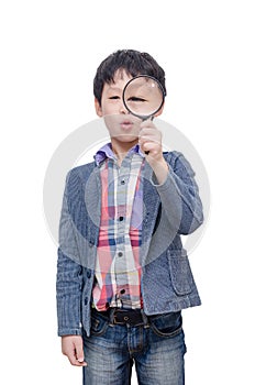 Boy with magnifying glass over white