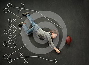 Boy making a diving catch for football