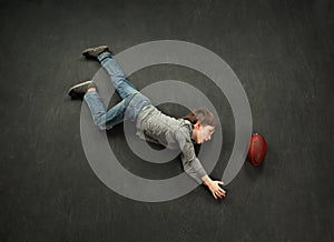 Boy making a diving catch for football