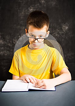 Boy making faces while studying