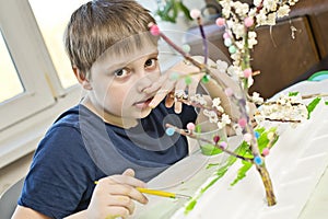 Boy making flowering apple tree garden layout.