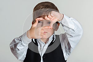 Boy making frame with hands