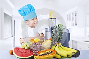 Boy making juice with a juice extractor