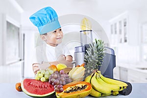 Boy making juice with a juice extractor photo