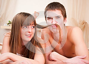 Boy is making a mustache of girl's hair