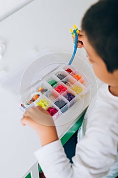 Boy making rubber bracelet