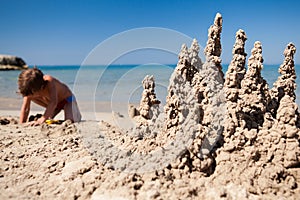 Boy making sand castle on beach